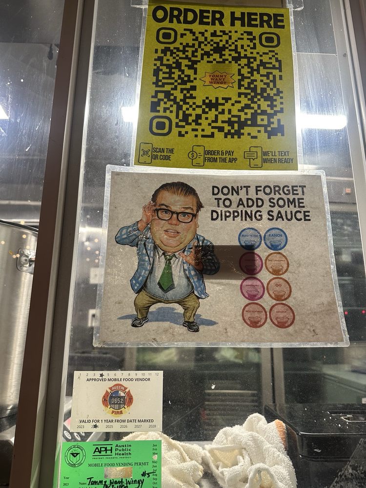 Food truck service window with QR code order sign, sauce add-ons, and mobile vending permits