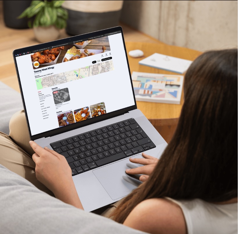 Laptop displaying a restaurant ordering website with sidebar navigation and combo sections